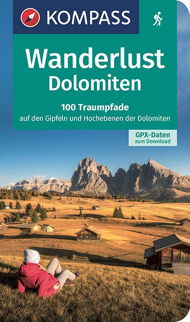 9783991213970 KOMPASS Wanderlust Dolomiten, Person liegt auf Wiese und schaut in die Landschaft