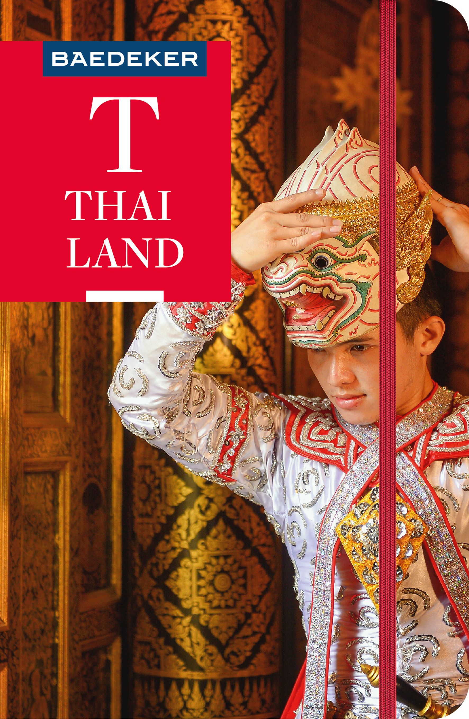 9783829718196 Baedeker Reiseführer Thailand, Cover Mann im traditionellem Gewand setzt sich eine Maske auf