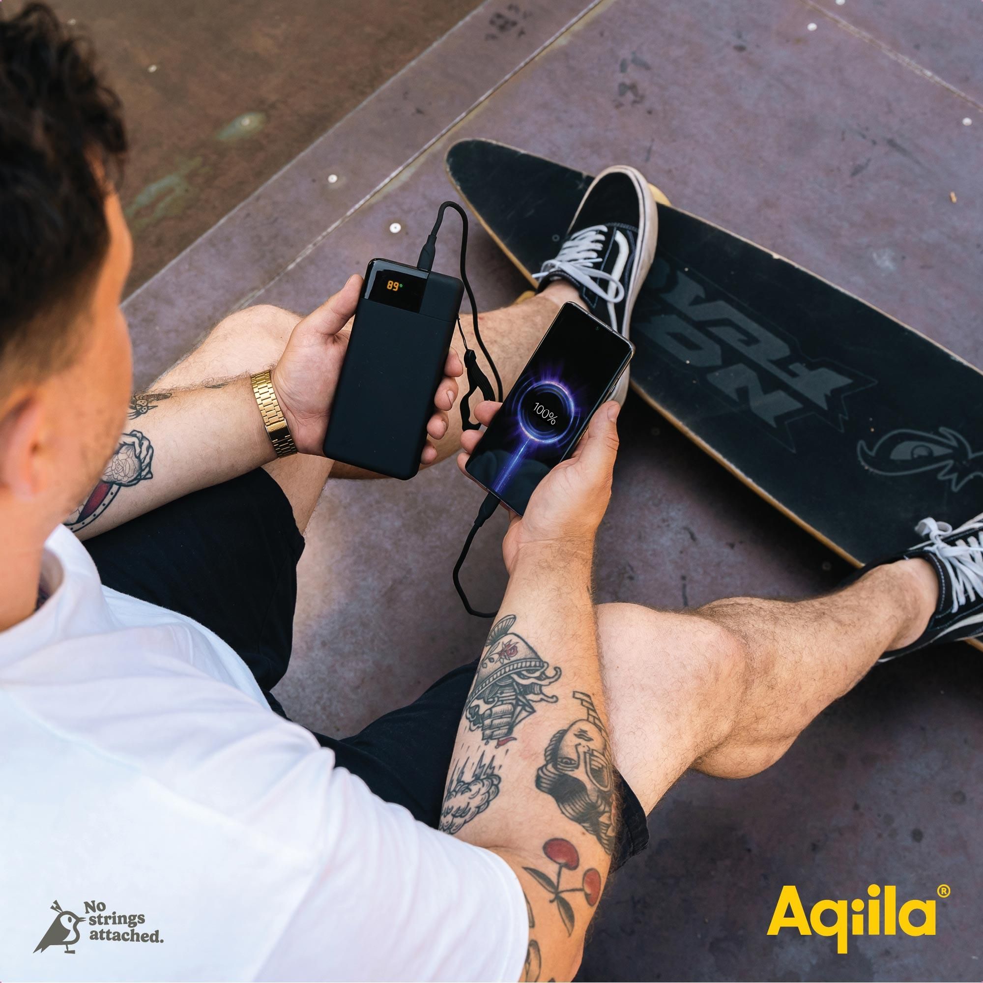 Power bank, Phone charging, Wireless charging, Tattooed arm, Skateboard