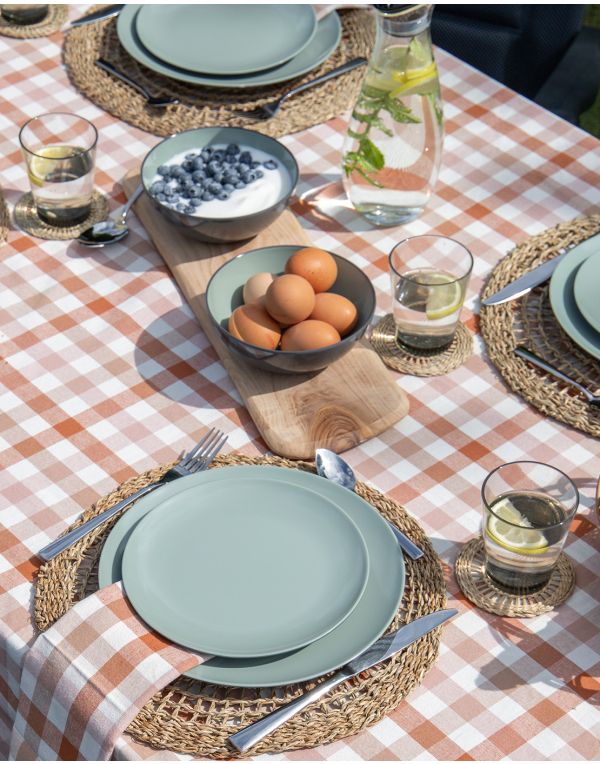 Eingedeckter Tisch mit Tellern, besteck und Deko